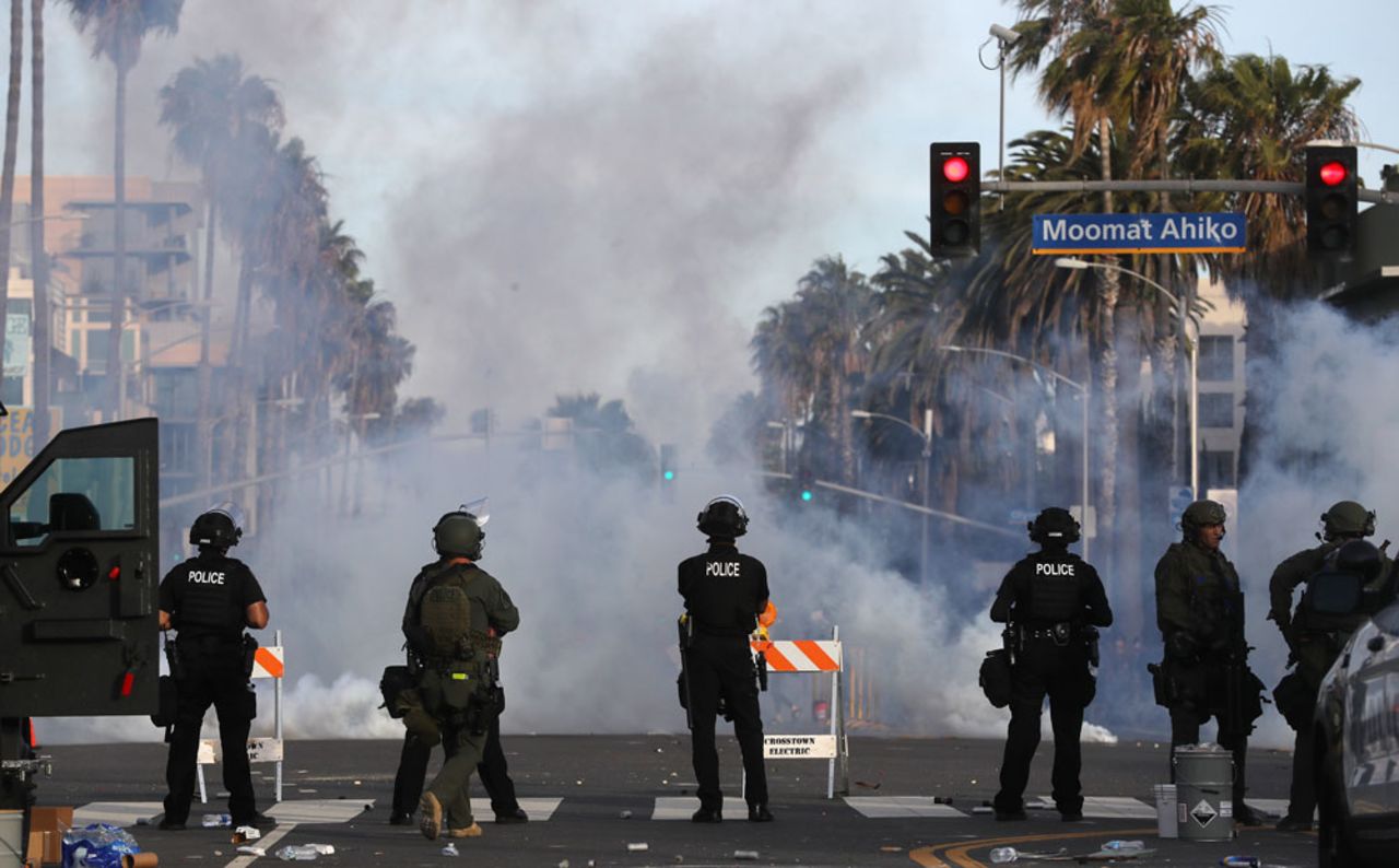 Police watch as tear gas is deployed during demonstrations in the aftermath of George Floyd’s death on May 31, in Santa Monica, California. 