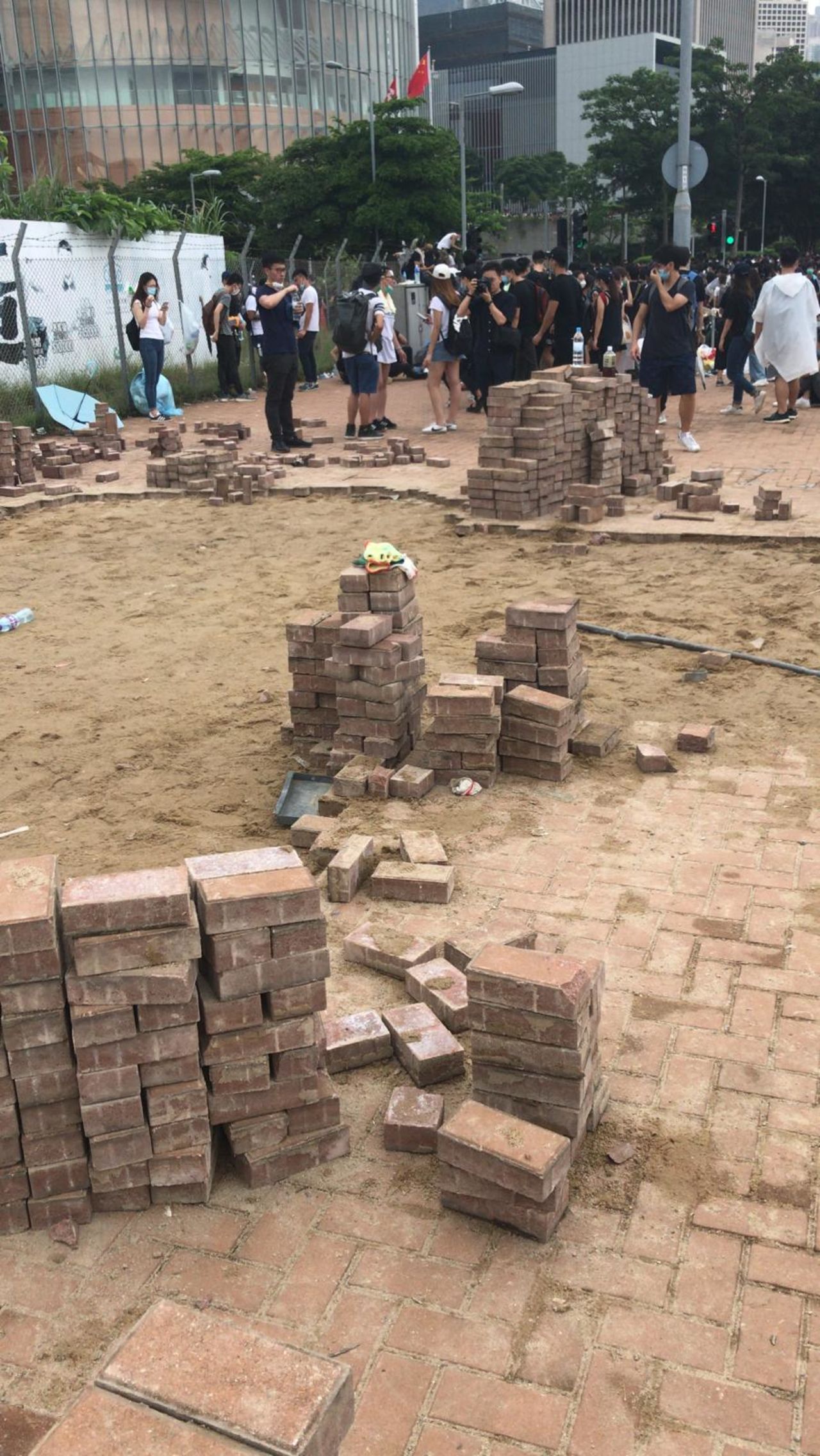 Hong Kong protesters dig up bricks from the pavements. 