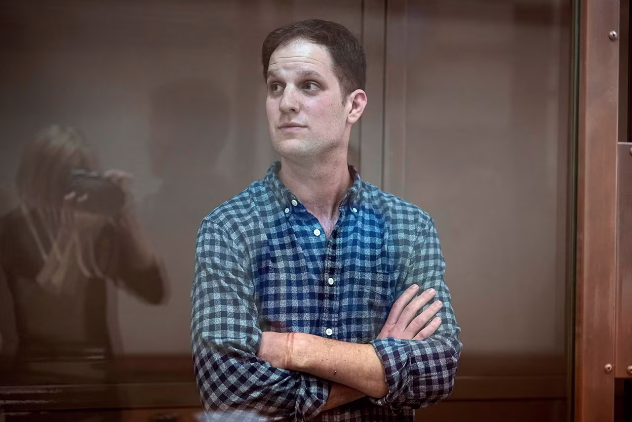 Wall Street Journal reporter Evan Gershkovich stands in a glass cage in a courtroom at the Moscow City Court on April 18. 