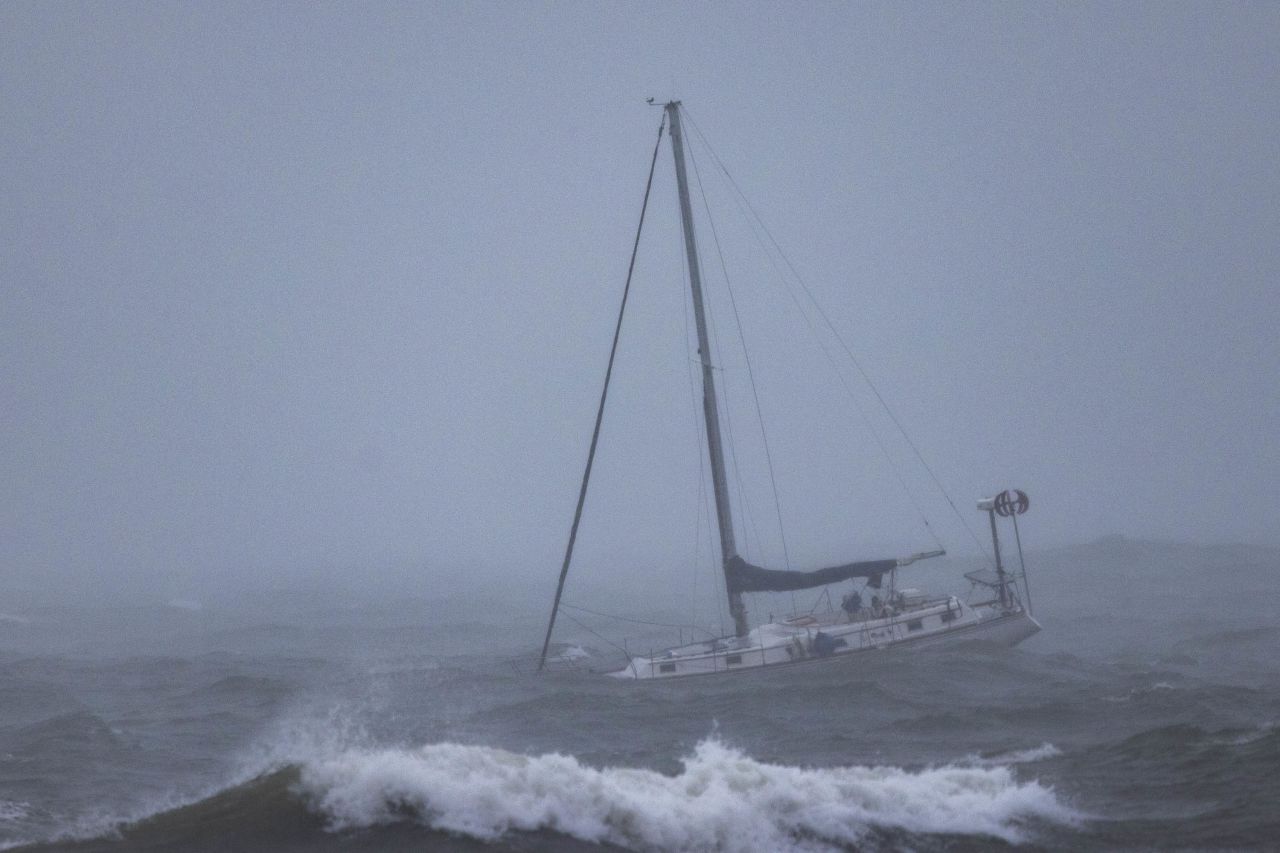 A boat moored offshore is tossed by rough waters in Santa Barbara.