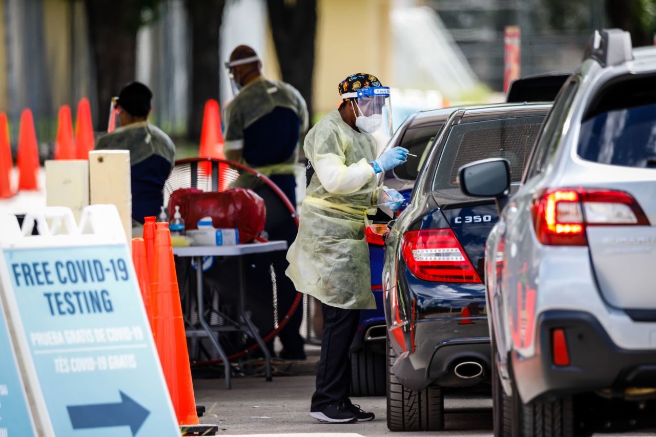 A health care worker administers a Covid-19 swab test in Miami on August 6.