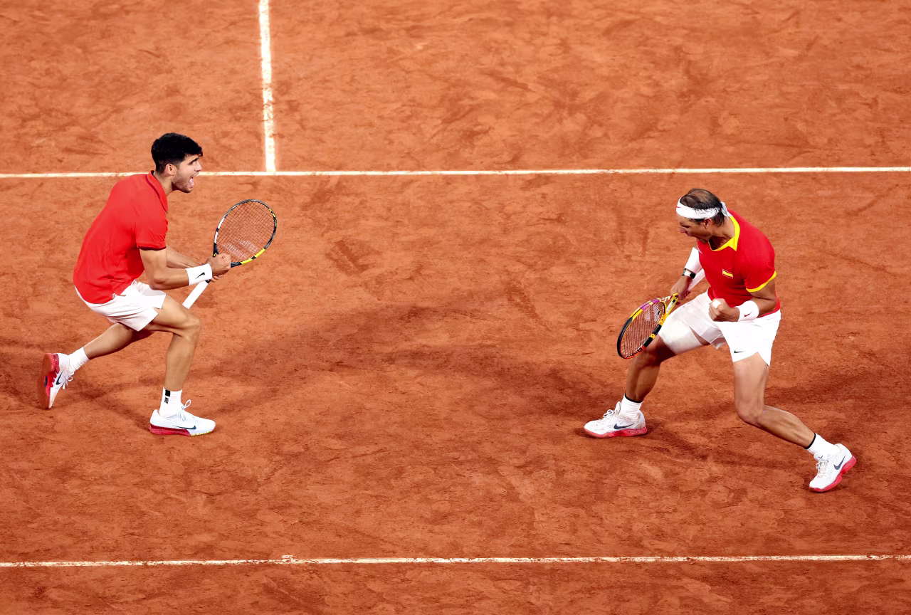 Spain's Carlos Alcaraz, left, and Rafael Nadal celebrate. 