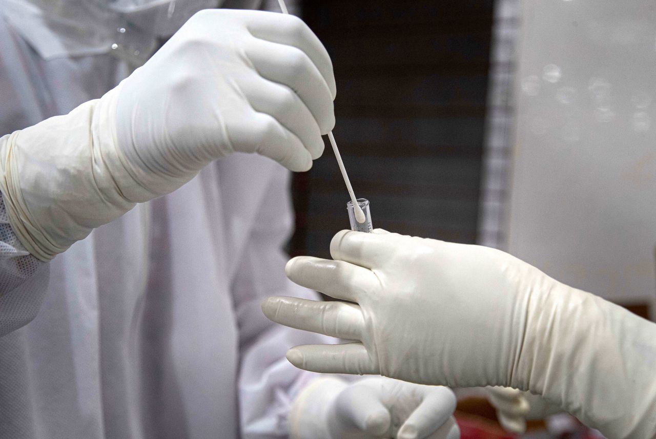 A doctor collects samples for a coronavirus swab test in Gauhati, India on Sunday.