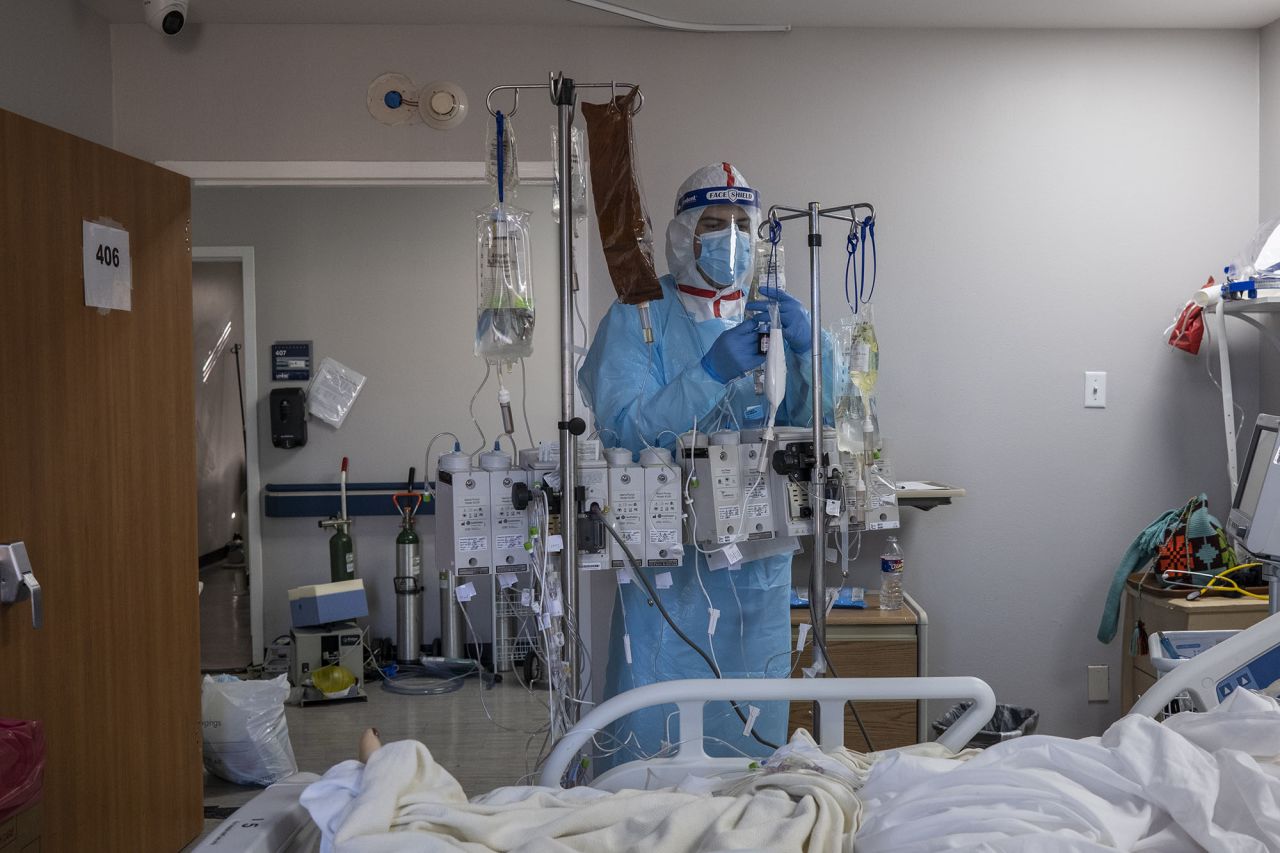 Medical staff member Alan Araiza checks of an IV for a patient in the Covid-19 intensive care unit at the United Memorial Medical Center on December 7 in Houston.