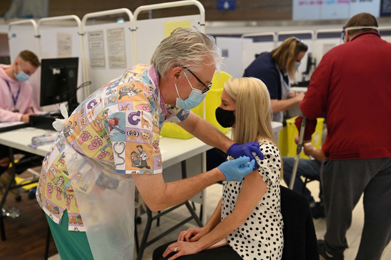 A health worker administers a dose of the BioNTech/Pfizer Covid-19 vaccine at a vaccination clinic in Derby, England, on March 31. 