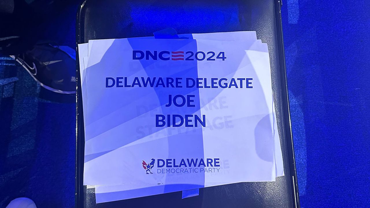 A sign sign on a chair in the front row of the Delaware delegation names President Joe Biden as a delegate.