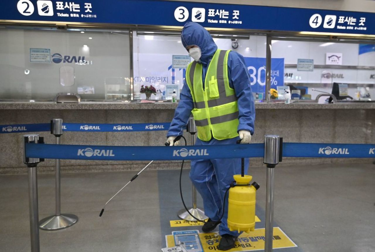 A worker wearing protective gear sprays disinfectant at a railway station in Daegu, South Korea, on Wednesday.