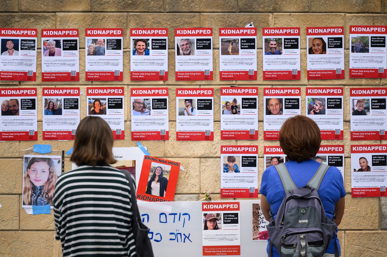 Photographs of some of those taken hostage by Hamas are seen on October 18, in Tel Aviv, Israel.