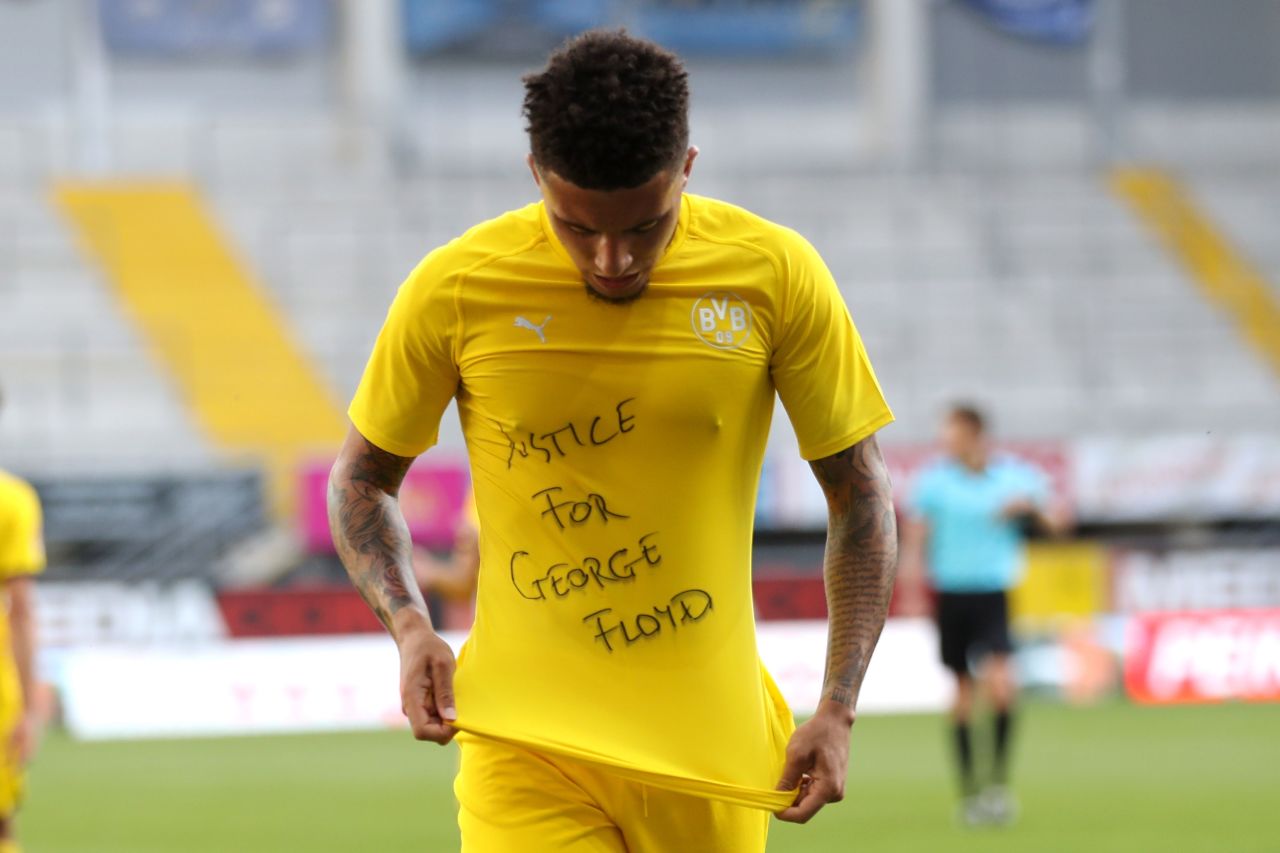 Dortmund's midfielder Jadon Sancho shows a "Justice for George Floyd" shirt as he celebrates after scoring his team's second goal during a game in Paderborn, Germany on May 31.