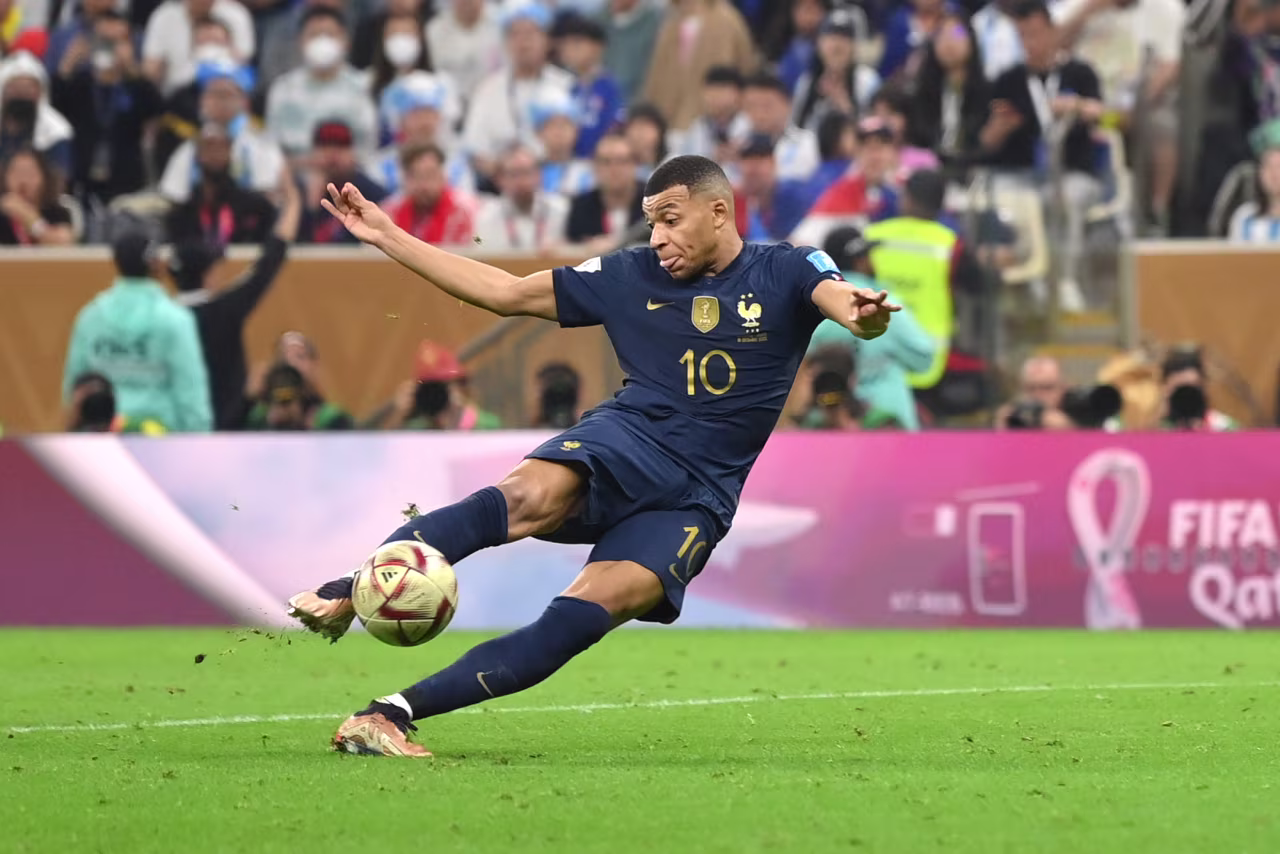 France's Kylian Mbappe scores his second goal Sunday, tying the match at 2-2.