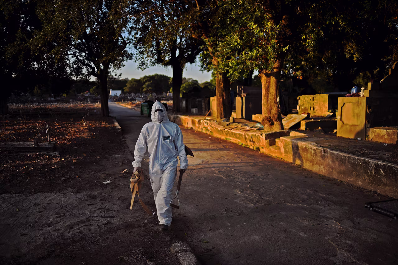 A cemetery worker wearing protective clothing prepares to bury a victim of Covid-19 at the Sao Franciso Xavier cemetery in Rio de Janeiro, Brazil, on May 29.