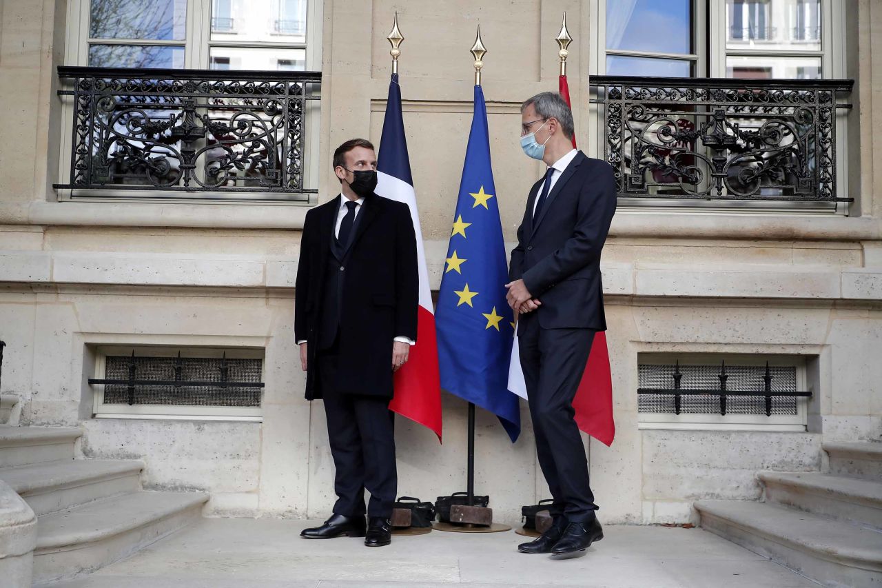 French President Emmanuel Macron, left, speaks with Wolfgang Wagner, Deputy Head of Mission at the Austrian embassy, before signing a condolence book for victims of the Vienna attack, in Paris, on Tuesday.