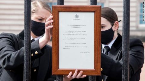 A sign announcing Prince Philip's death is placed on the gates of Buckingham Palace in London.