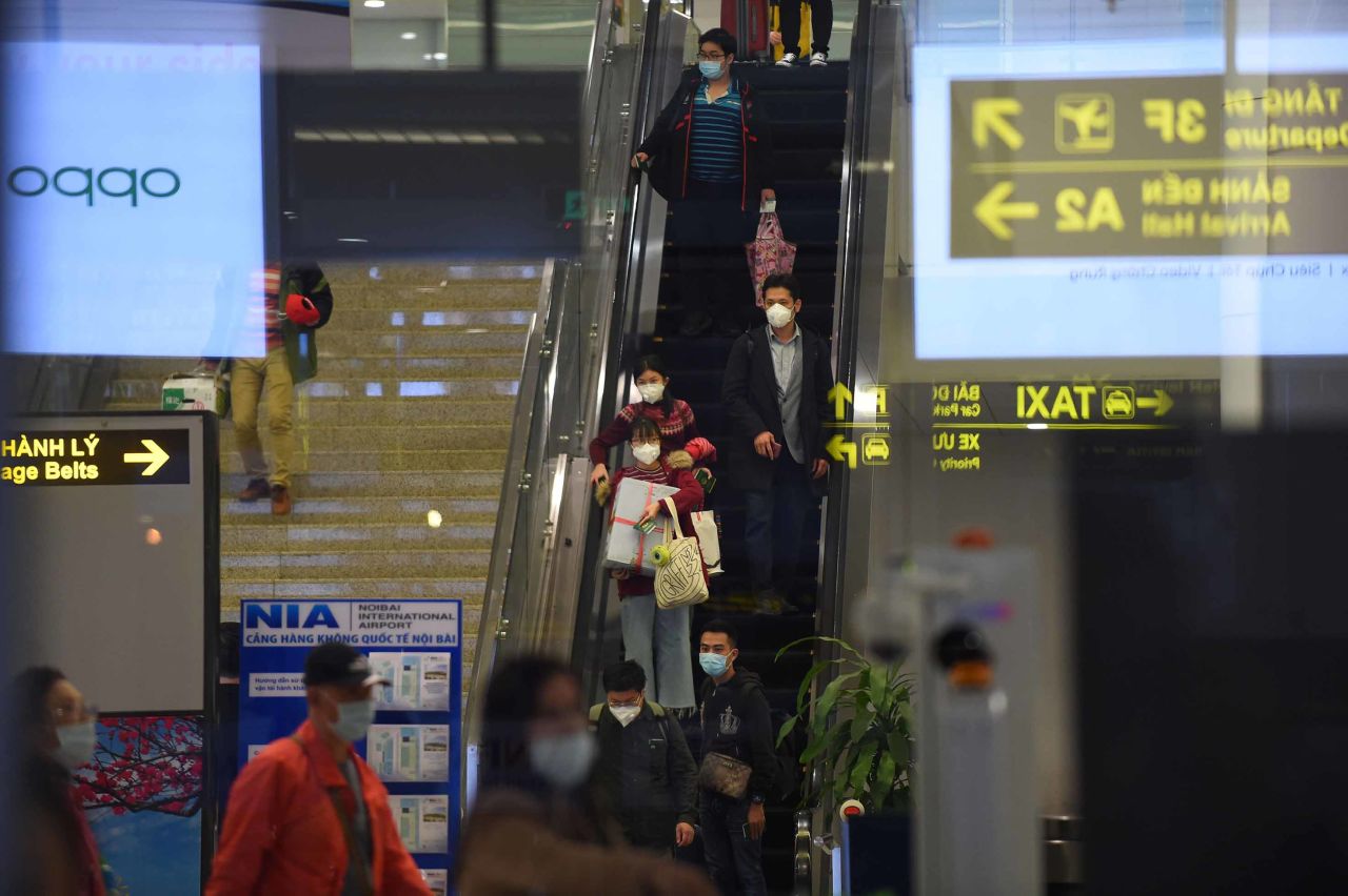 Travelers are seen wearing protective face masks at Noi Bai international airport in Hanoi, Vietnam on February 2, where flights to mainland China have been suspended over fears of the coronavirus outbreak.