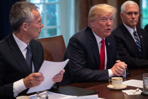 President Donald Trump (C) meets with NATO Secretary General Jens Stoltenberg (L) as Vice President Mike Pence looks on in the Cabinet Room at the White House in Washington, DC, on May 17, 2018. 