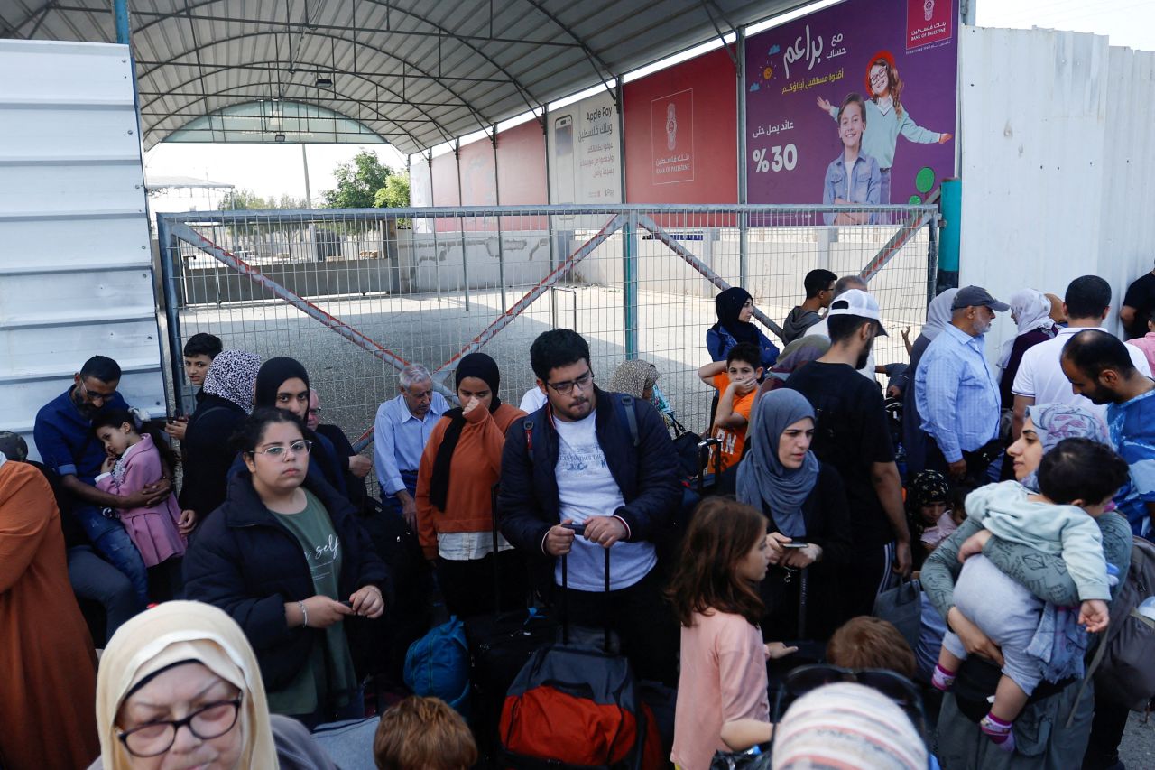 People gather on the Gaza side of the Rafah border crossing on October 14.