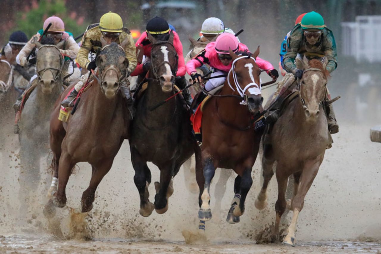 Horses fight for position in the final turn during the 145th running of the Kentucky Derby at Churchill Downs in May 2019, in Louisville, Kentucky. 