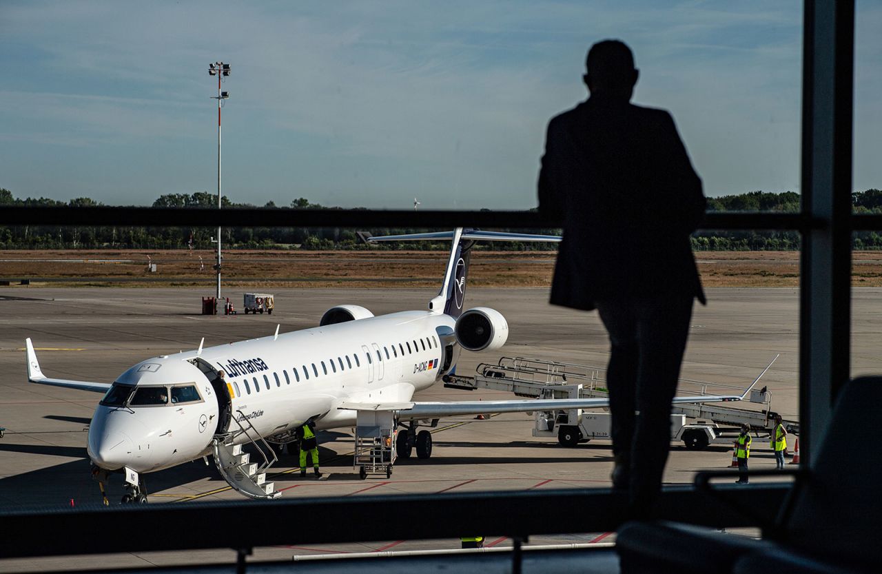 A passenger stands in the departure hall at Münster-Osnabrück Airport and looks at a Lufthansa aircraft on the tarmac on June 2. 