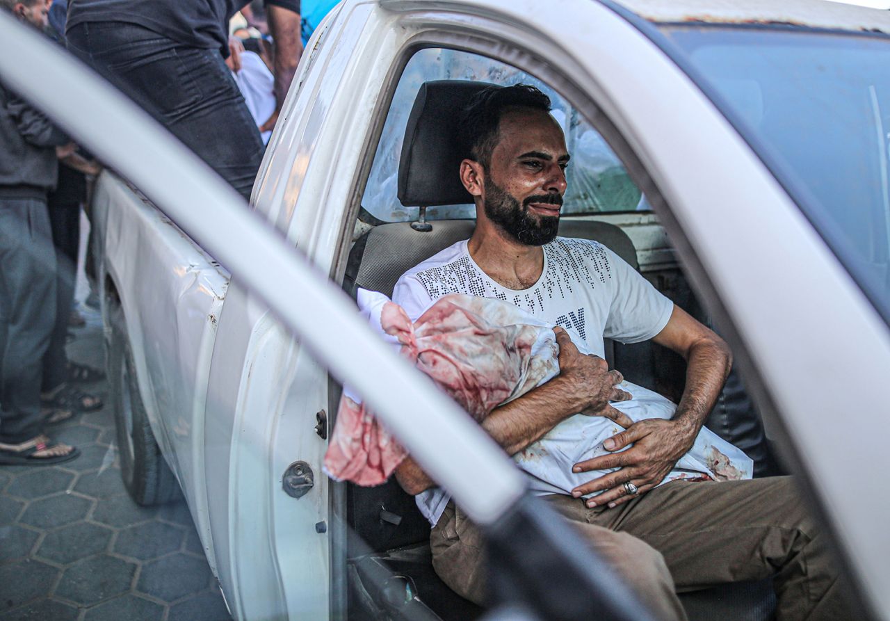 Relatives mourn as bodies are carried for burial from Al Aqsa Martyrs Hospital in Deir Al-Balah, Gaza, on October 31. 