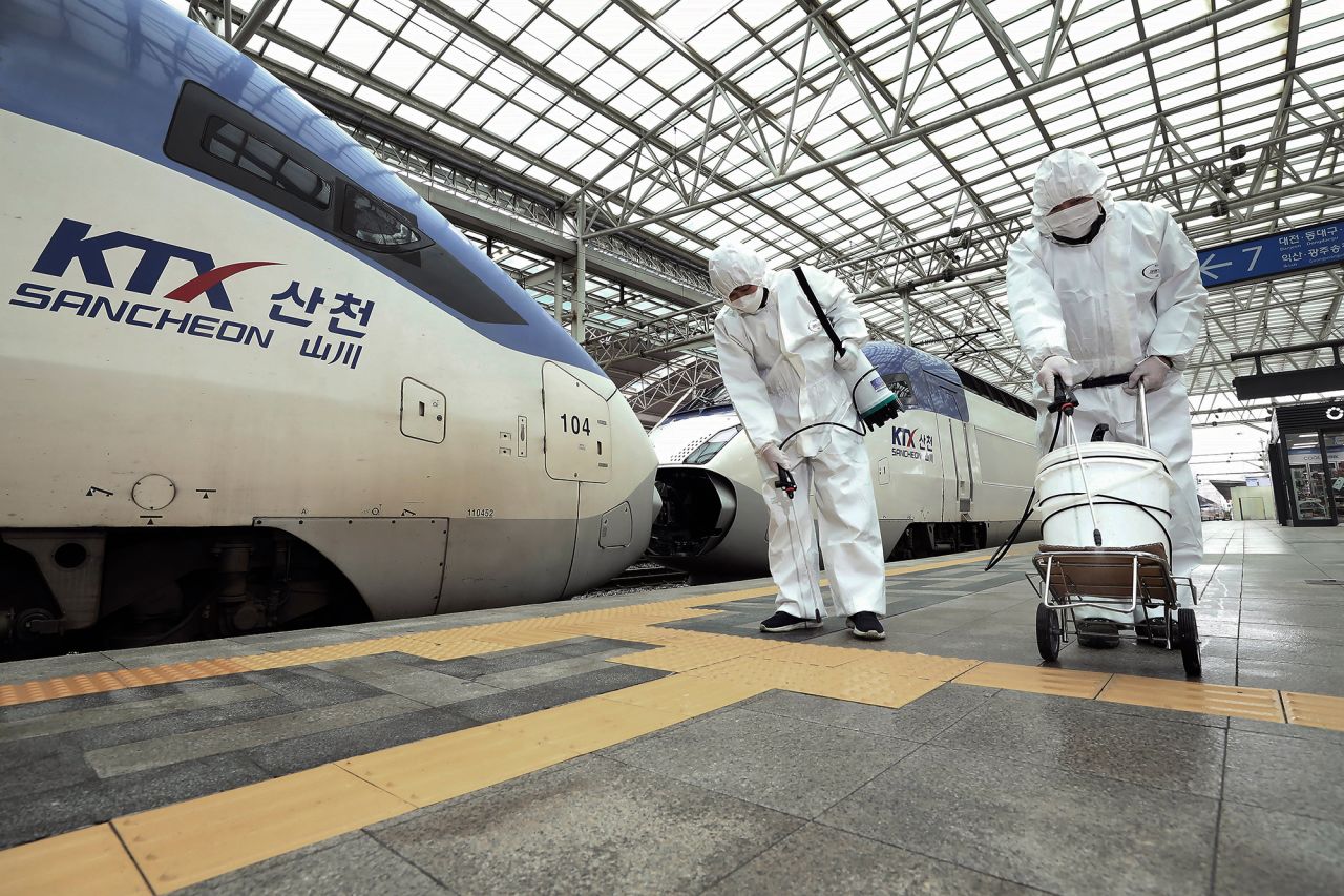 Workers wearing protective gear spray disinfectant as a precaution against the new coronavirus at Seoul Railway Station in Seoul, South Korea, Tuesday, February 25. 