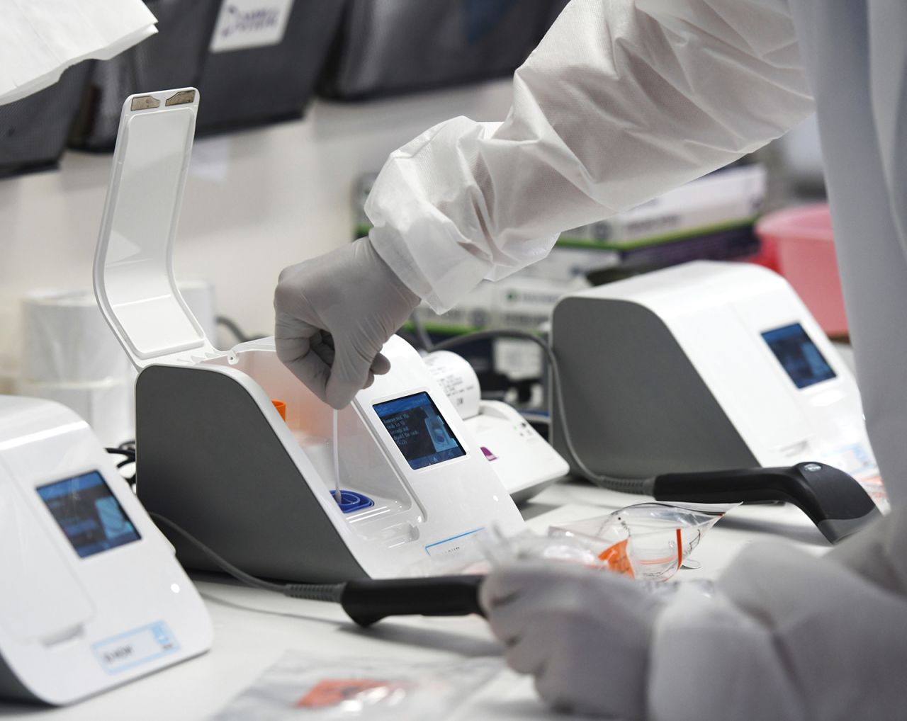 A?medical laboratory scientist inserts a patient's swab sample into the coronavirus testing machine in the lab at Stamford Hospital in Stamford, Connecticut on May 14.