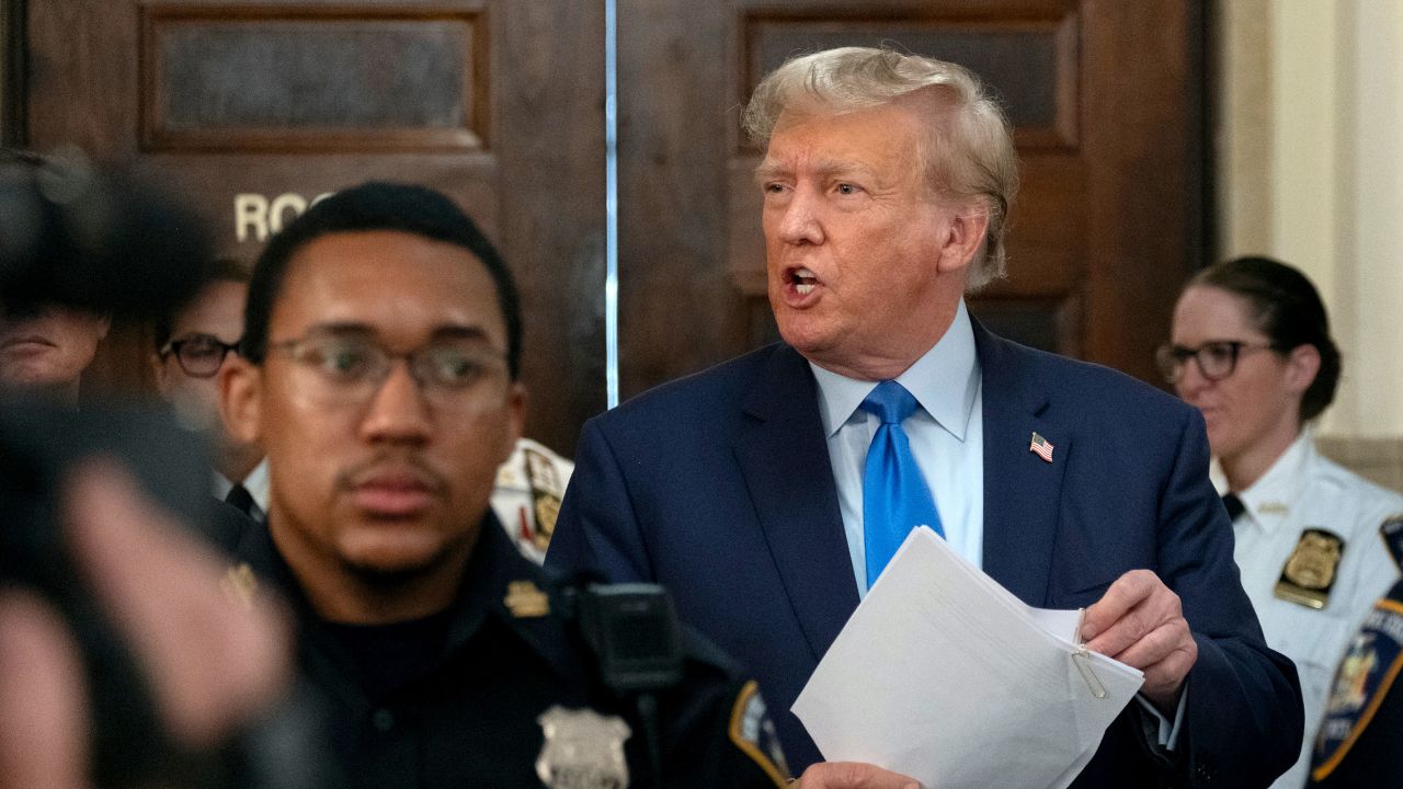 Former President Donald Trump speaks with journalists during a midday break from court proceedings in New York, on Monday.