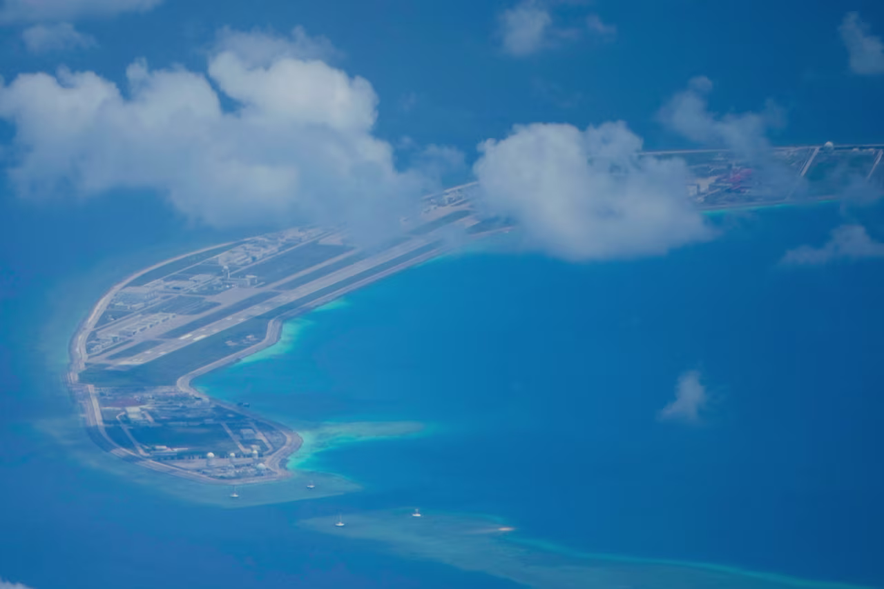 A Chinese air strip is visible beside structures and buildings on Mischief Reef in the Spratly group of islands in the South China Sea, March 20, 2022.