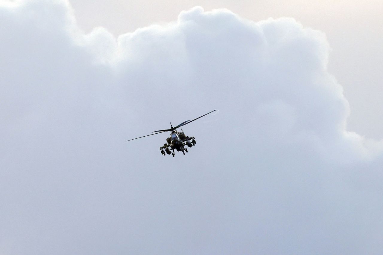 An Israeli Air Force Apache helicopter flies over the border area with Lebanon in northern Israel on December 12.