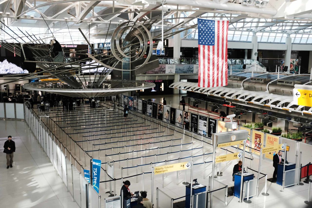 People walk through an international departure terminal at John F. Kennedy Airport in New York City, on March 7.