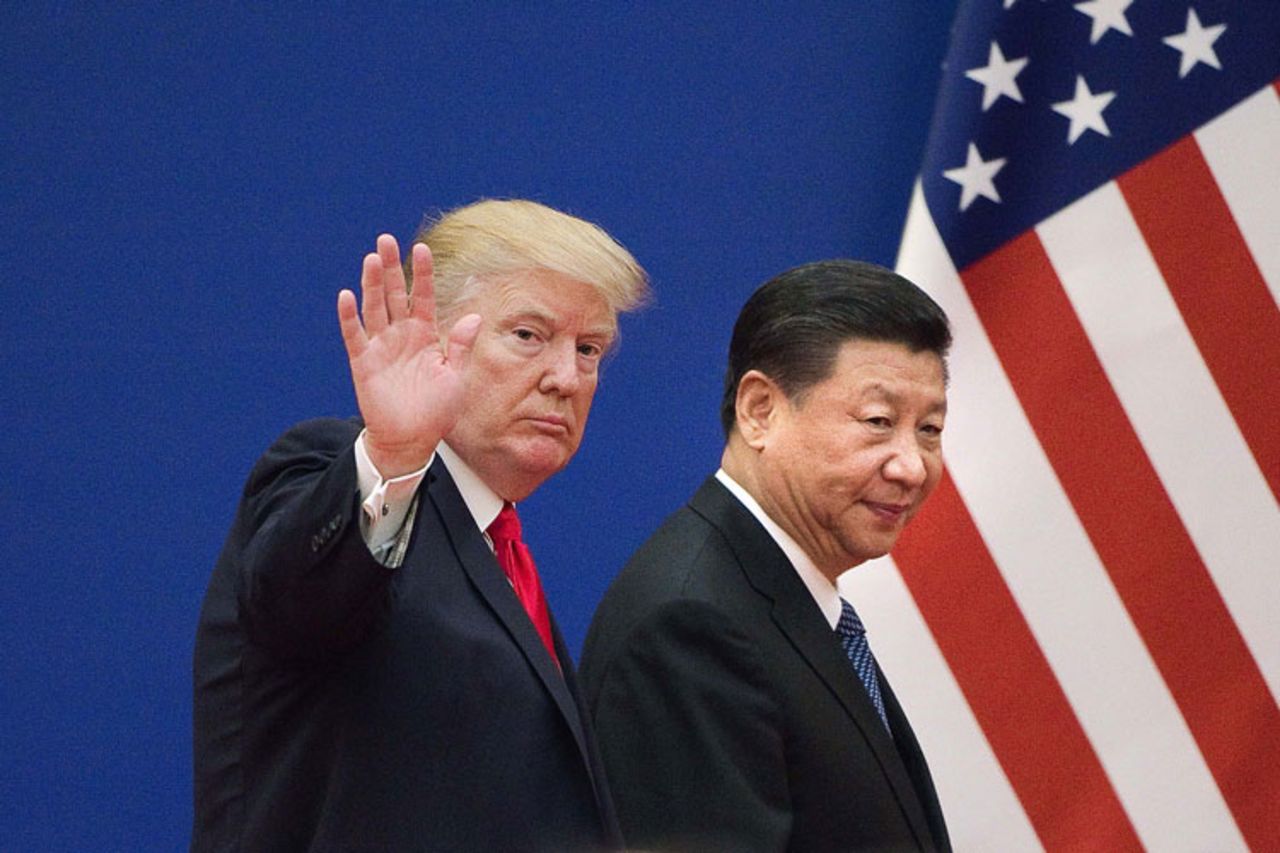 US President Donald Trump and China's President Xi Jinping leave a business leaders event at the Great Hall of the People in Beijing on November 9, 2017.