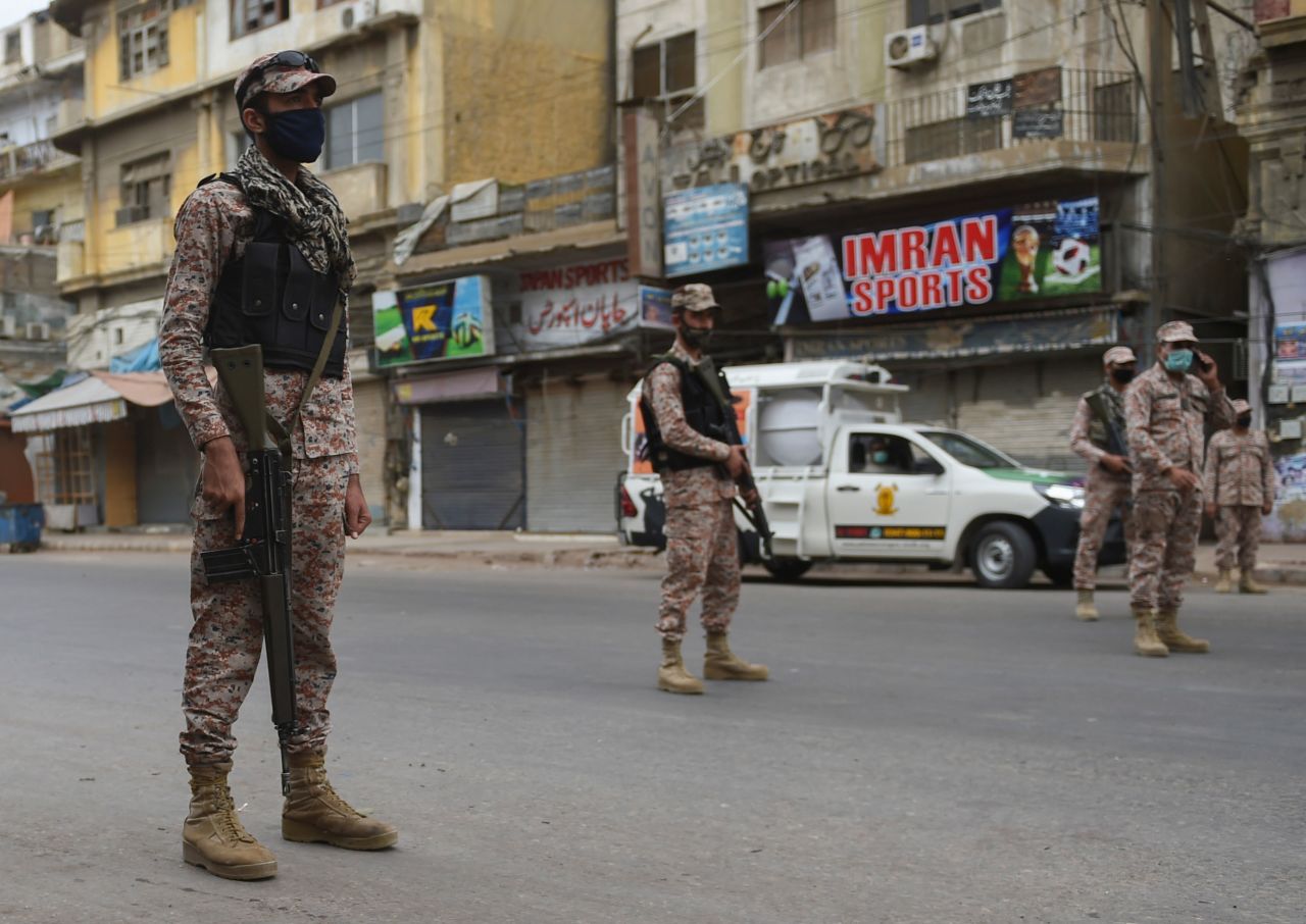 Soldiers stand guard on a deserted street during lockdown in Karachi, Pakistan on March 23.