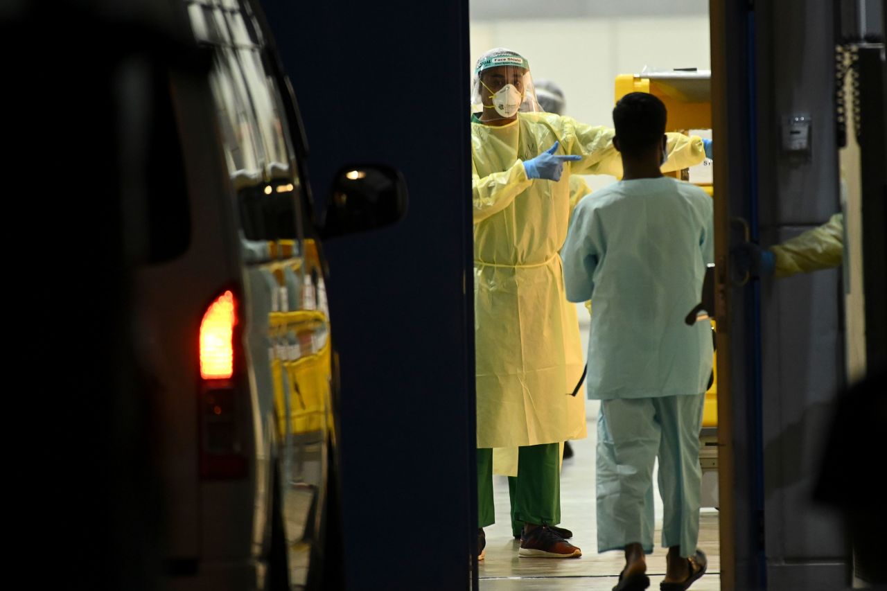 Medical staff wait for patients to be transferred to a temporary hospital, as a preventive measure against the spread of Covid-19, in Singapore on April 10.