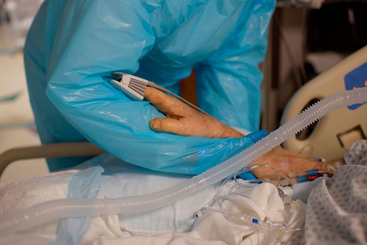 A health care worker comforts a patient in the Covid-19 ward at United Memorial Medical Center in Houston, Texas on December 4.