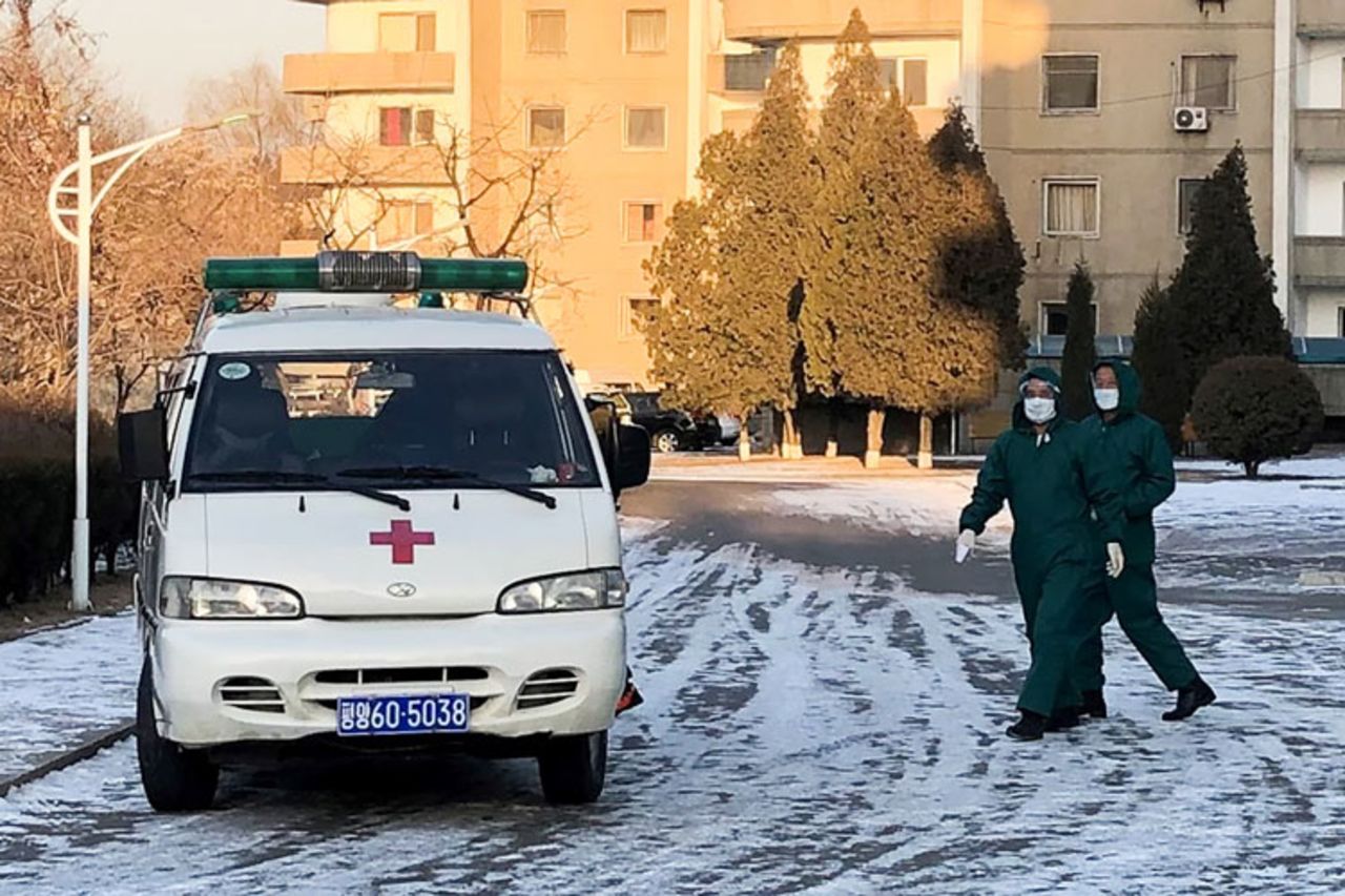 Doctors in medical masks and protective suits by an ambulance vehicle at the Munsu-dong diplomatic compound in Pyongyang, North Korea, amid an outbreak of the coronavirus on February 6. 