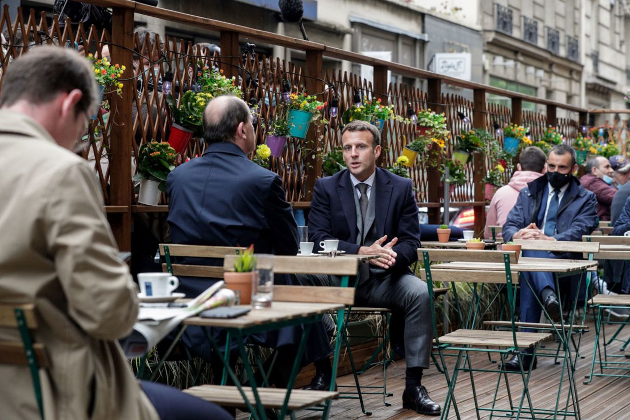 French President Emmanuel Macron (R) and French Prime Minister Jean Castex (L) are having coffees at a cafe terrace in Paris, France on May 19.