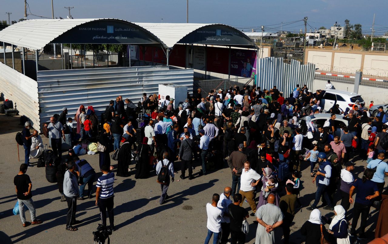 Palestinians gather outside?the Rafah?border crossing with Egypt in the hope of getting permission to leave Gaza on Monday.