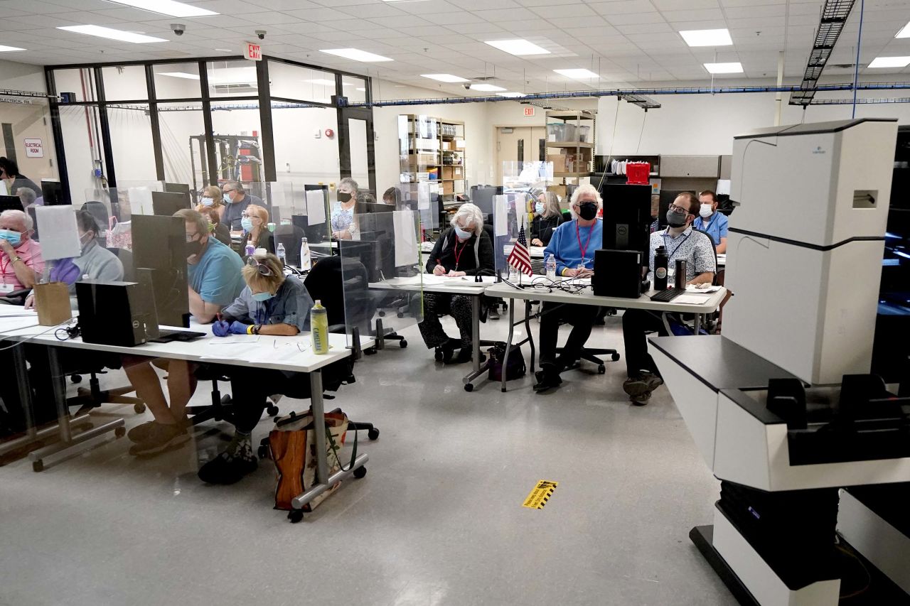 Maricopa County elections officials and observers watch as ballots are tallied at the Maricopa County Recorders Office in Phoenix, Arizona, on Wednesday, November 4.