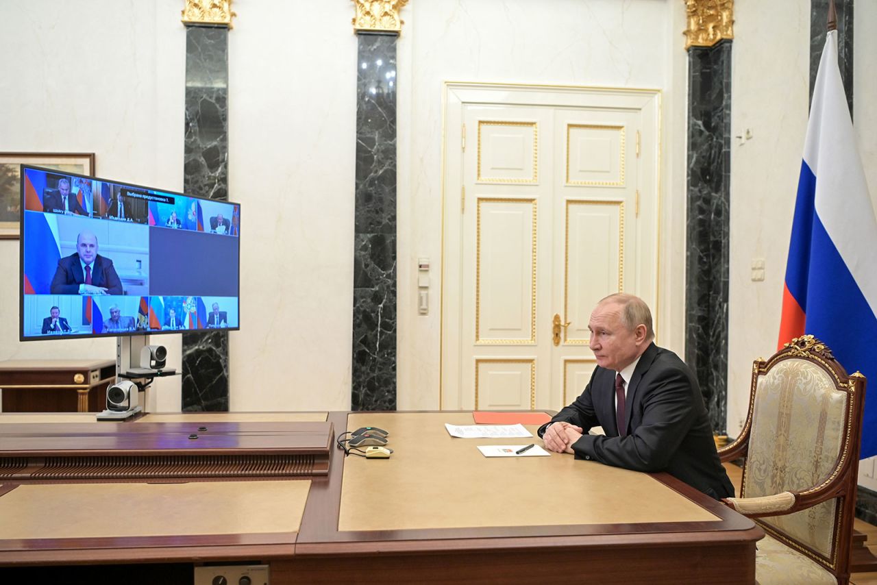 Russia President Vladimir Putin is seen in his office during a virtual meeting with members of his security council on February 25. 