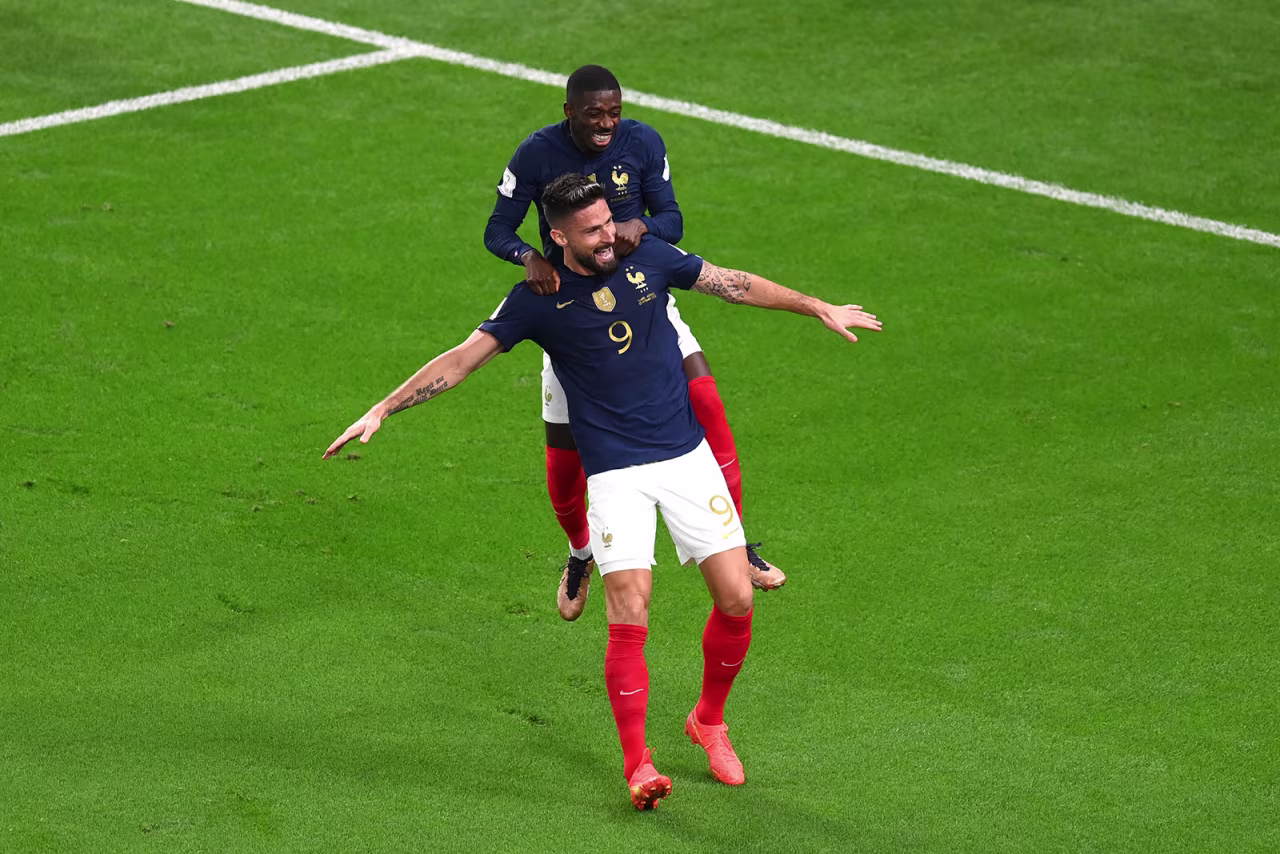 France's Olivier Giroud celebrates scoring a goal with their teammate Ousmane Dembele during a match against Australia on November 22.