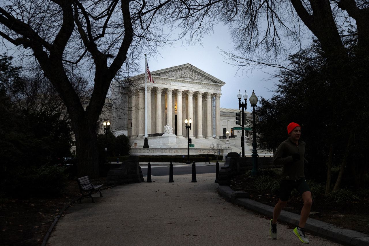 A person jogs in front of the US Supreme Court in Washington, DC, on January 31.