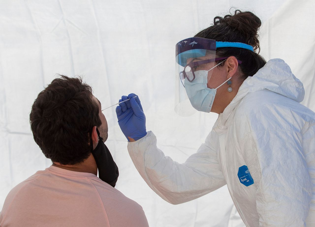 Lane County's Deputy Public Health Officer Dr. Lisandra Guzman uses a swab to collect a sample for a Covid-19 test at a site on Dec. 10, at Centro de Fe Church in Eugene, Oregon.