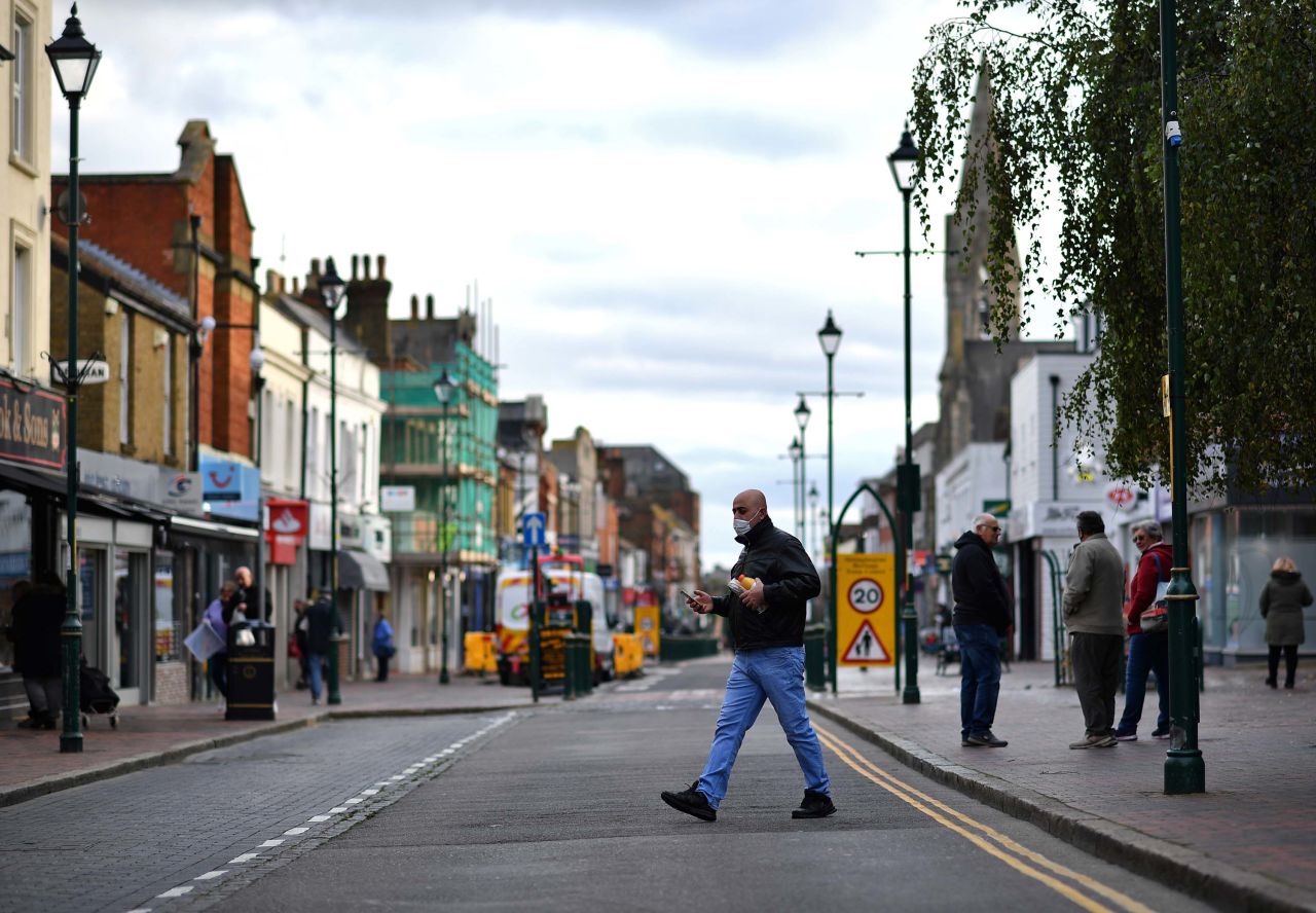 Pedestrians walk in a street in Sittingbourne, in the Swale district of Kent, England, which has become a coronavirus hotspot, on November 24. 