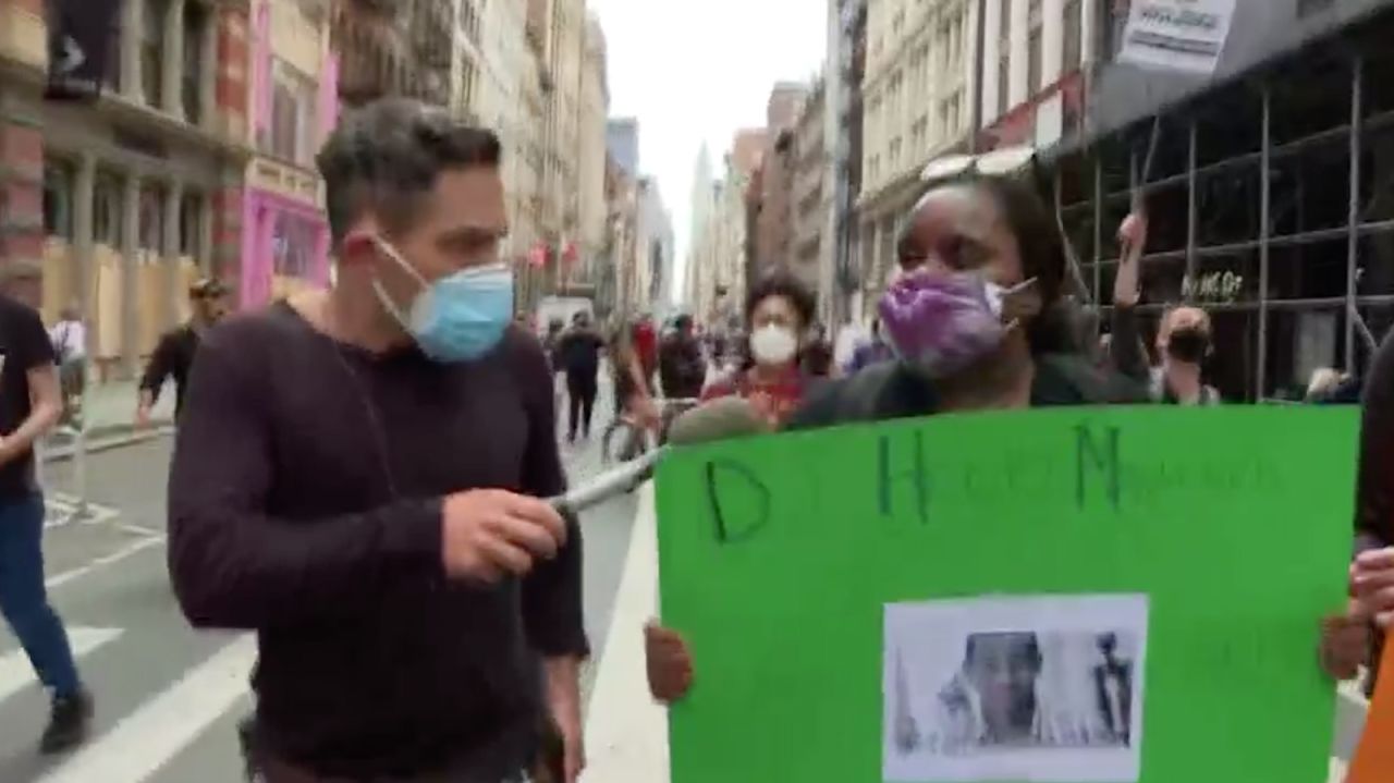 CNN’s Shimon Prokupecz speaks to a protester in New York on Tuesday.