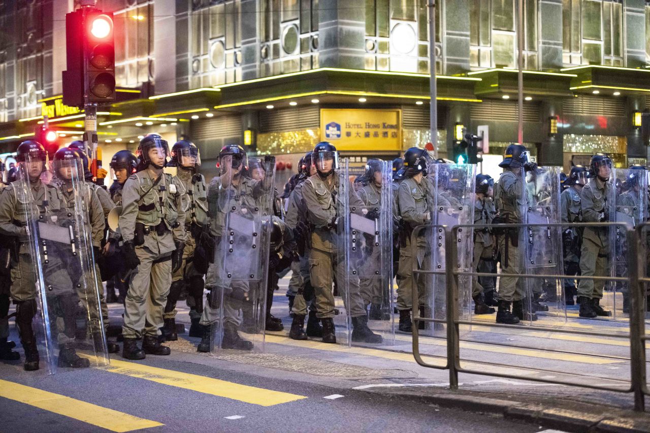 Police stand guard near the China Liaison Office in Hong Kong's Sai Ying Pun district Sunday.