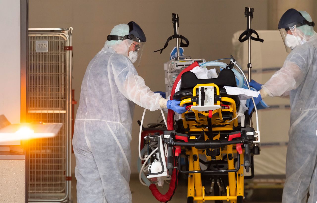 Medics take care of a coronavirus patient upon his arrival from Italy to a hospital in Dresden, Germany, on March 26.