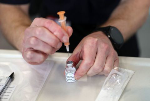 A member of the Hampshire Fire and Rescue Service prepares a dose of an AstraZeneca/Oxford Covid-19 vaccine at a temporary vaccination center in Hampshire, southern England, on February 4.