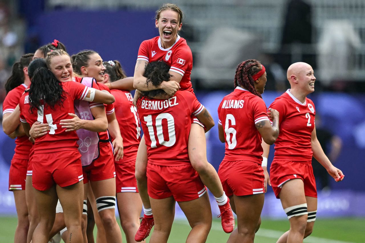 Canada's Piper Logan, center, celebrates with teammates after they defeated Australia in the women's rugby sevens match on Tuesday.