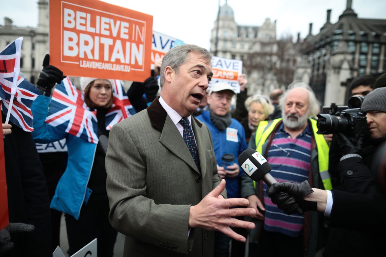 Crowds stand near former UKIP Leader Nigel Farage in Parliament Square outside the Palace of Westminster on Tuesday.