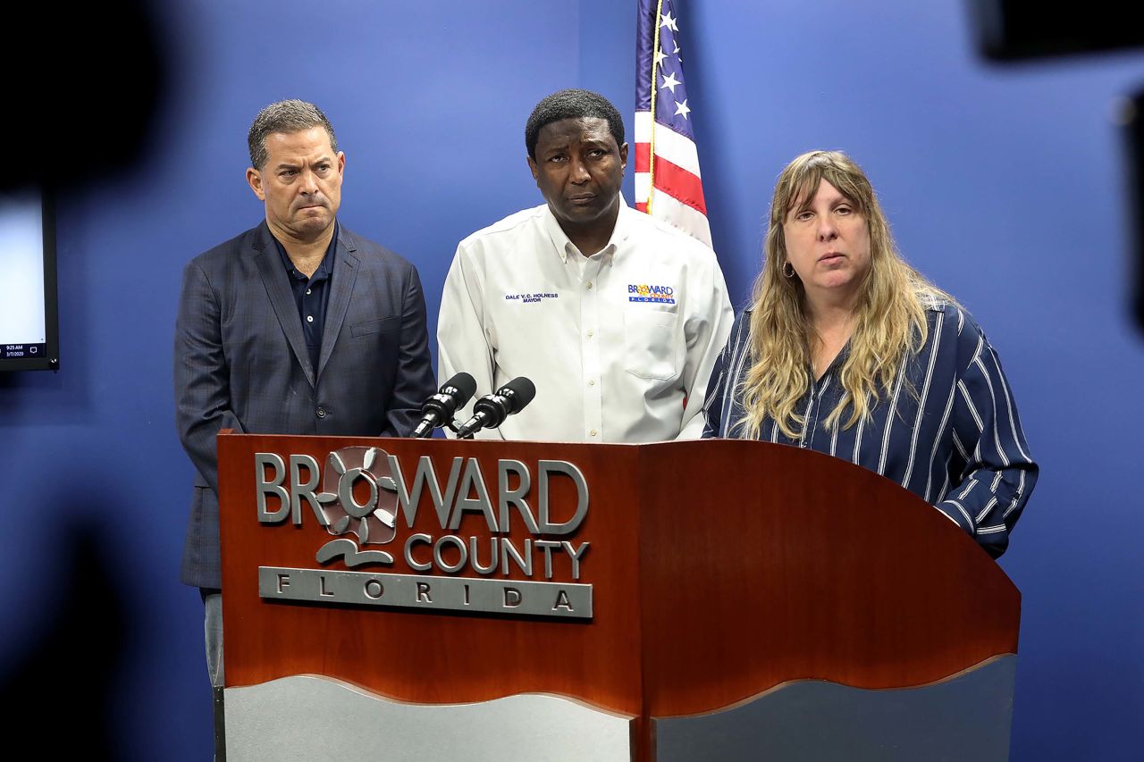 Broward County commissioner Michael Udine, Mayor Dale V.C. Holness, and Dr. Paula Thaqi, Director of the Florida Department of Health in Broward County take questions from the media about coronavirus cases in Plantation, Florida, on March 7.