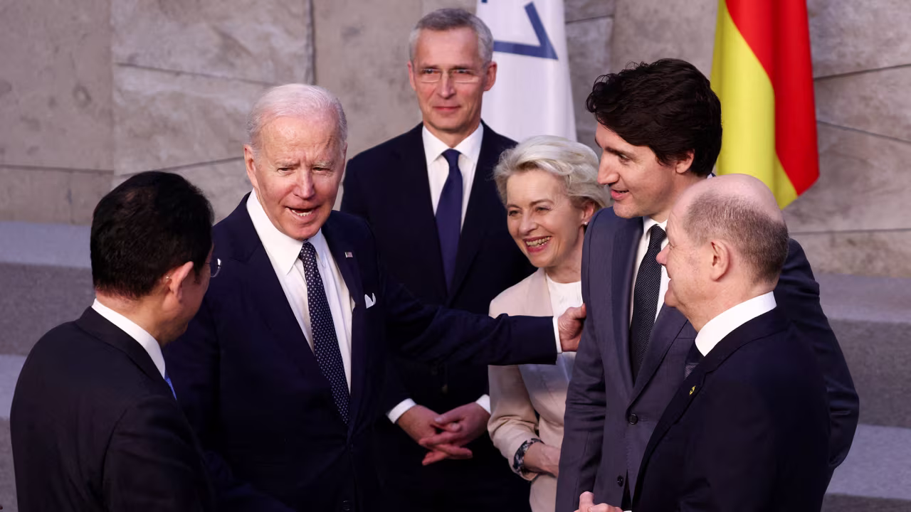 Japan's Prime Minister Fumio Kishida (left), U.S. President Joe Biden (second left) and Germany's Chancellor Olaf Scholz (right) speak with NATO Secretary General Jens Stoltenberg (center), European Commission President Ursula von der Leyen (third from right) and Canada's Prime Minister Justin Trudeau (second from right) before a G7 leaders' family photograph on March 24, 2022. 